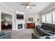 Spacious living room with fireplace, large windows, and comfortable seating at 1505 Mclaurin Ln, Fuquay Varina, NC 27526