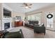 Comfortable living room with fireplace, plush seating, and natural light at 1505 Mclaurin Ln, Fuquay Varina, NC 27526