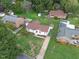 Aerial view of a house surrounded by lush greenery, showcasing its location and neighborhood at 1709 Hawthorne Lane Ln, Burlington, NC 27215