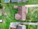 Aerial view of a home showcasing its layout, roof, and surrounding yard with mature trees at 1709 Hawthorne Lane Ln, Burlington, NC 27215