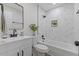This bathroom features a glass-enclosed tub/shower, with modern tile backsplash, and a white vanity with a granite top at 1709 Hawthorne Lane Ln, Burlington, NC 27215