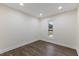 This empty bedroom has neutral-colored walls, recessed lighting, a window, and dark hardwood-style flooring at 1709 Hawthorne Lane Ln, Burlington, NC 27215