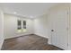 This simple bedroom features modern recessed lighting, wood flooring, and a window allowing ample natural light at 1709 Hawthorne Lane Ln, Burlington, NC 27215