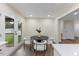 Cozy dining area featuring a round table and modern chairs, with doors to the backyard at 1709 Hawthorne Lane Ln, Burlington, NC 27215