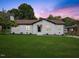 Charming home with a brick exterior, well-manicured lawn, and a picturesque sunset backdrop at 1709 Hawthorne Lane Ln, Burlington, NC 27215
