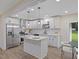 Modern kitchen with white cabinets, stainless steel appliances, and an island breakfast bar at 1709 Hawthorne Lane Ln, Burlington, NC 27215
