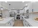 Modern kitchen with white cabinets, stainless steel appliances, and a quartz countertop island at 1709 Hawthorne Lane Ln, Burlington, NC 27215