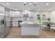 Open kitchen featuring a center island, stainless steel appliances, and modern white cabinetry at 1709 Hawthorne Lane Ln, Burlington, NC 27215