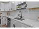 A bright kitchen features quartz counters, modern fixtures, and stainless steel appliances at 1709 Hawthorne Lane Ln, Burlington, NC 27215