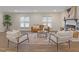Bright living room with a cozy fireplace, neutral furniture, and a large area rug at 1709 Hawthorne Lane Ln, Burlington, NC 27215