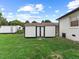 The backyard features a storage shed with contrasting white and black colors, suitable for storage at 1709 Hawthorne Lane Ln, Burlington, NC 27215
