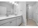 Bright bathroom features a double sink vanity and glass enclosed shower with tile flooring at 173 Churchill Way, Clayton, NC 27520