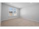 Bedroom featuring carpet floors and a large window overlooking the neighborhood at 173 Churchill Way, Clayton, NC 27520
