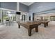 Game room showcasing pool tables, lounge seating and natural light at 173 Churchill Way, Clayton, NC 27520