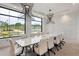 Bright conference room with contemporary lighting, large windows, and a long table at 173 Churchill Way, Clayton, NC 27520