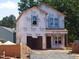 New construction with Tyvek wrap and architectural details, awaiting finishing touches for its future residents at 1804 Falls Landing Dr, Raleigh, NC 27614