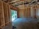 Unfinished living room featuring a large sliding glass door leading to the backyard, awaiting customization and finishing at 1804 Falls Landing Dr, Raleigh, NC 27614