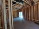 Unfinished living room with exposed framing and a sliding glass door, showcasing the potential for a bright living space at 1804 Falls Landing Dr, Raleigh, NC 27614