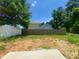 View of the backyard, showcasing a wooden fence and partial views of neighboring houses at 1808 Falls Landing Dr, Raleigh, NC 27614