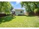 View of the back of the home from the spacious lawn and fenced yard at 200 W Corbin St, Hillsborough, NC 27278