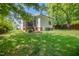 A spacious backyard with lush green grass featuring the home's screened in porch at 200 W Corbin St, Hillsborough, NC 27278