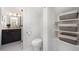 Bathroom featuring a toilet and built-in storage shelves with decorative baskets at 200 W Corbin St, Hillsborough, NC 27278