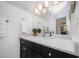 Bathroom featuring a marble countertop, a well-lit vanity, and a decorative plant at 200 W Corbin St, Hillsborough, NC 27278