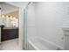 Bathroom showcasing a white subway tile surround on the tub and a view into the vanity area at 200 W Corbin St, Hillsborough, NC 27278