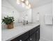 Bright bathroom featuring a white marble countertop, dark cabinets, and modern fixtures at 200 W Corbin St, Hillsborough, NC 27278
