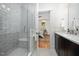 Bright bathroom featuring a glass enclosed shower with subway tile, and marble vanity with views into the main bedroom at 200 W Corbin St, Hillsborough, NC 27278