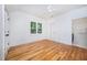 Bedroom featuring hardwood floors, a window, and a ceiling fan at 200 W Corbin St, Hillsborough, NC 27278