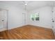 Bright bedroom with wooden floors, ceiling fan, and access to the bathroom at 200 W Corbin St, Hillsborough, NC 27278