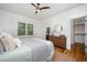 Well-lit bedroom with wood floors and view of bathroom at 200 W Corbin St, Hillsborough, NC 27278
