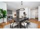 Dining room with black table with a view into the kitchen at 200 W Corbin St, Hillsborough, NC 27278