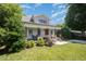 Attractive home showcasing a well-kept lawn and mature trees surrounding the property at 200 W Corbin St, Hillsborough, NC 27278