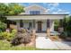 Charming home featuring a welcoming front porch with brick columns and beautiful landscaping at 200 W Corbin St, Hillsborough, NC 27278