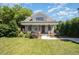 Inviting home with a well-manicured lawn, attractive landscaping, and a covered front porch at 200 W Corbin St, Hillsborough, NC 27278