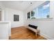 Bright hallway with hardwood floors and a bench seat under a large window at 200 W Corbin St, Hillsborough, NC 27278