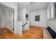 Hallway with hardwood floors and a view out the window at 200 W Corbin St, Hillsborough, NC 27278