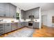 Bright kitchen with gray cabinets, stainless steel appliances, white countertops, and hardwood floors at 200 W Corbin St, Hillsborough, NC 27278