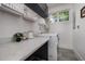 Bright laundry room features modern appliances, a quartz countertop, and ample storage at 200 W Corbin St, Hillsborough, NC 27278