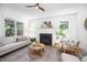 Comfortable living room featuring a fireplace, hardwood floors, and large windows at 200 W Corbin St, Hillsborough, NC 27278
