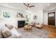 Cozy living room with a fireplace, hardwood floors, and an elegant area rug at 200 W Corbin St, Hillsborough, NC 27278