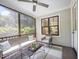 Relax on the screened porch with ceiling fan, perfect for enjoying the outdoors at 200 W Corbin St, Hillsborough, NC 27278
