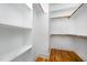 A large walk-in closet provides generous storage with built-in shelving and wooden rods at 200 W Corbin St, Hillsborough, NC 27278