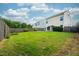 A backyard with a lush green lawn, a metal shade canopy, and a wood fence at 2007 October Dr, Durham, NC 27703