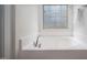 Bathroom with soaking tub and window with blinds at 2007 October Dr, Durham, NC 27703