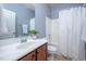 Bright bathroom featuring a vanity, mirror, and tub with a shower curtain at 2007 October Dr, Durham, NC 27703