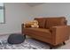 This bedroom features a cozy brown leather sofa, patterned rug, and plush bunny at 2007 October Dr, Durham, NC 27703
