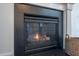 Close-up of a cozy fireplace with black stone and a basket at 2007 October Dr, Durham, NC 27703